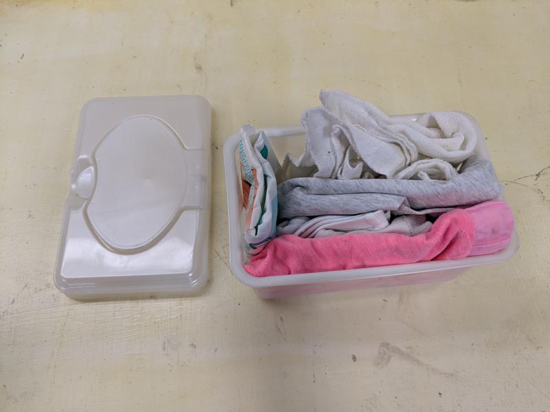 Kid clothes and wipes in a wipe container