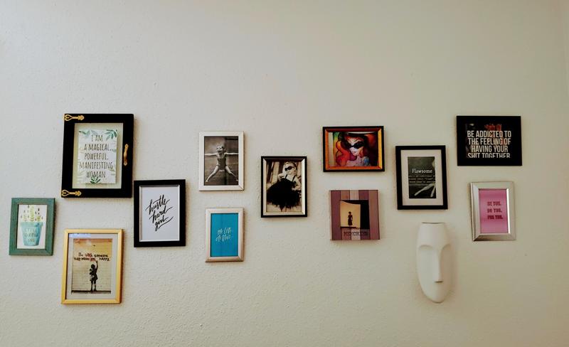 gallery wall of framed decorative art and photos